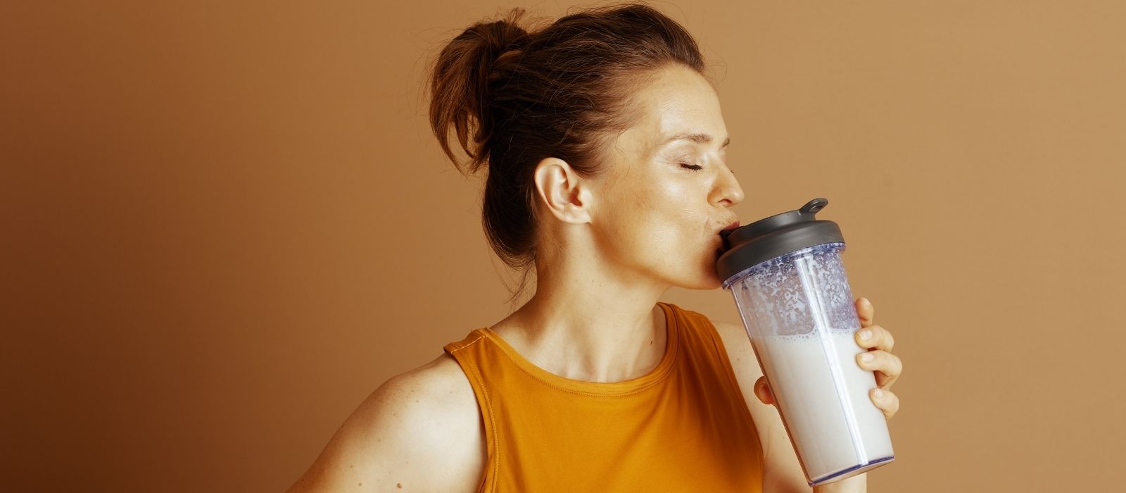 woman eating protein food warm light