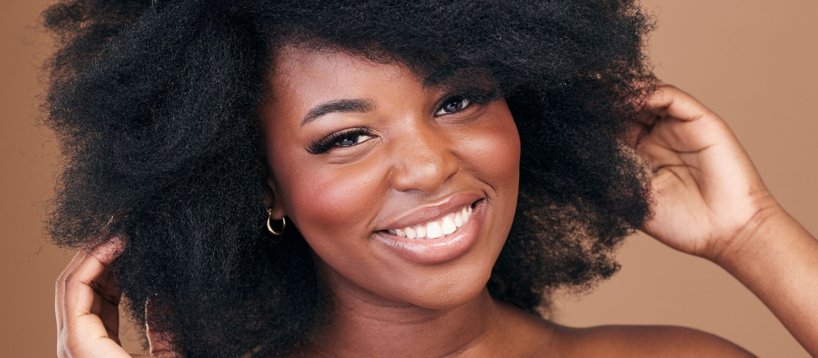 woman washing hair warm natural light bathroom