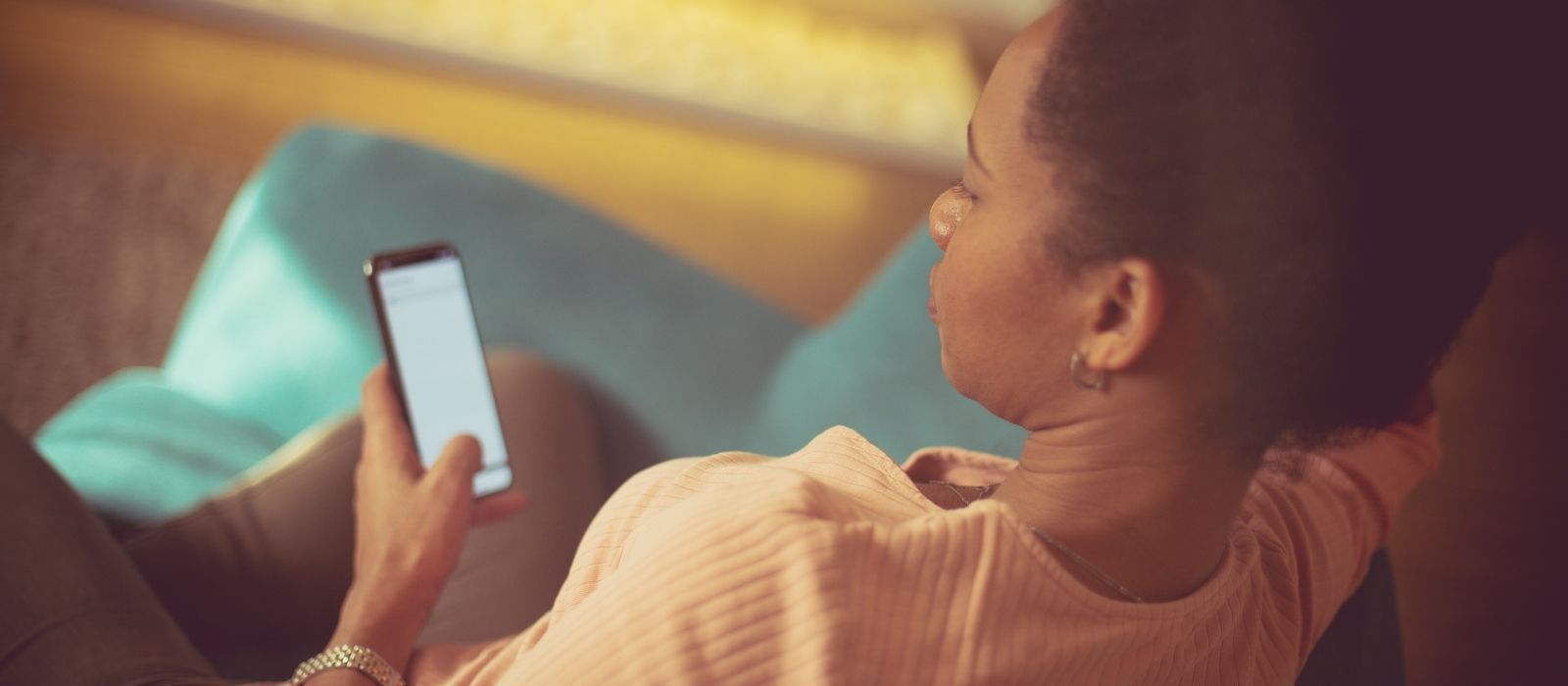 Woman on a sofa looking at her phone