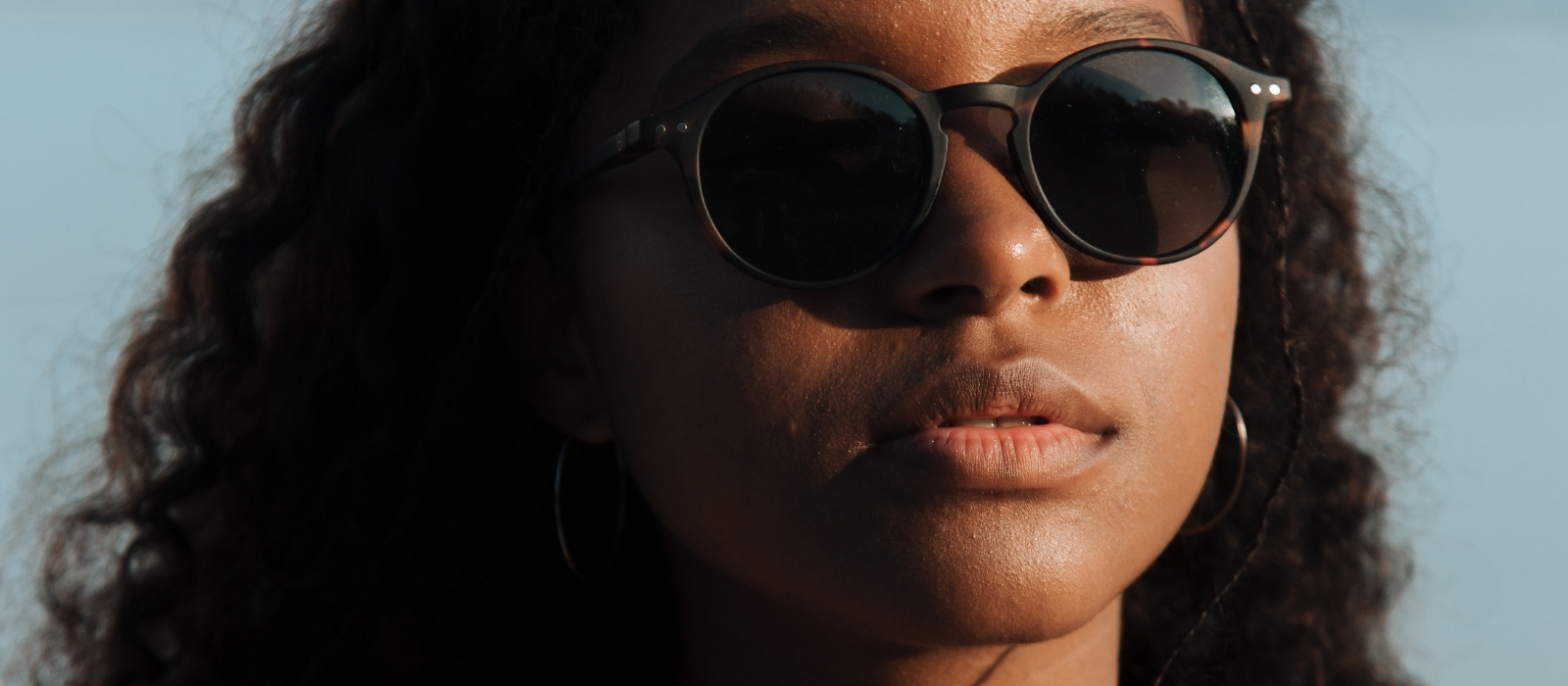 Woman with even glowing skin in bright natural light