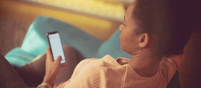 Woman on a sofa looking at her phone