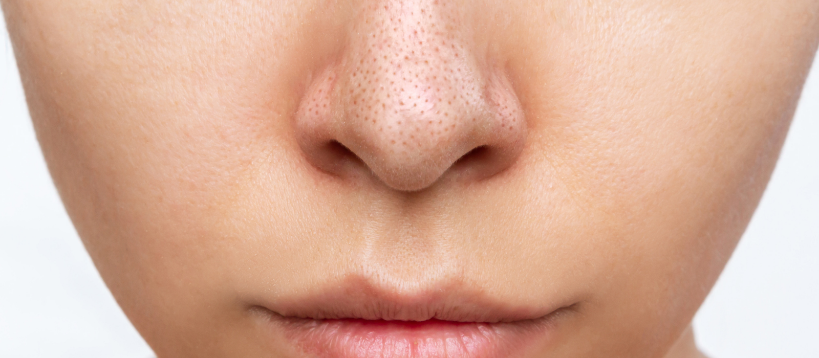 Woman examining clear skin in soft natural light