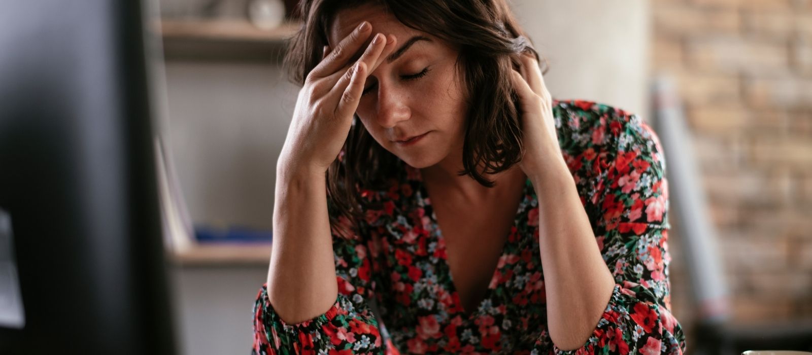 Woman sitting quietly with hands around a warm mug