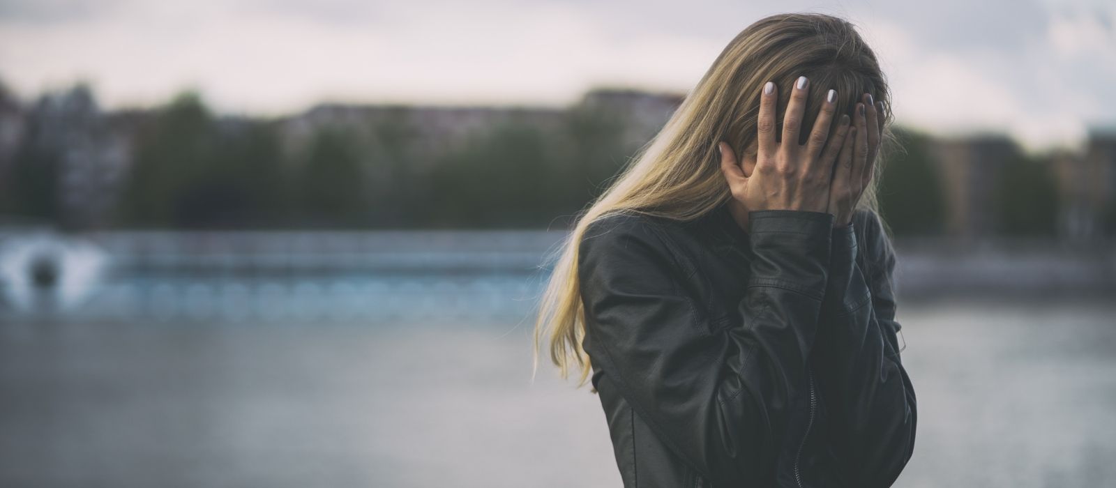 woman grieving sad contemplative window