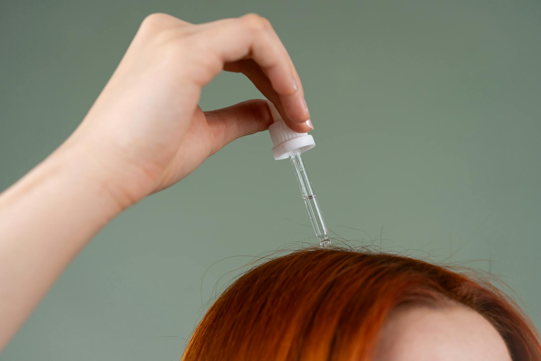 Woman at clinic consultation touching her hair near window