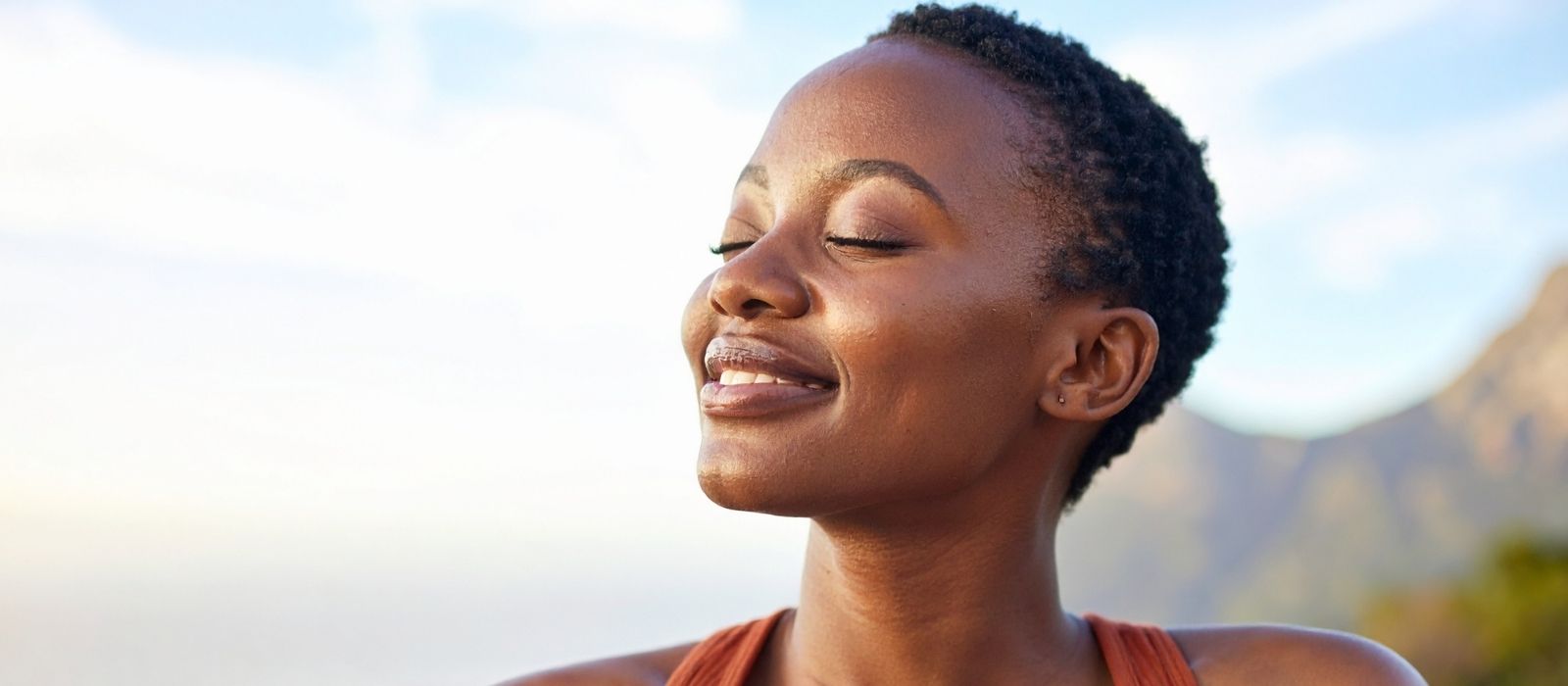 Woman gently touching her hair in soft light