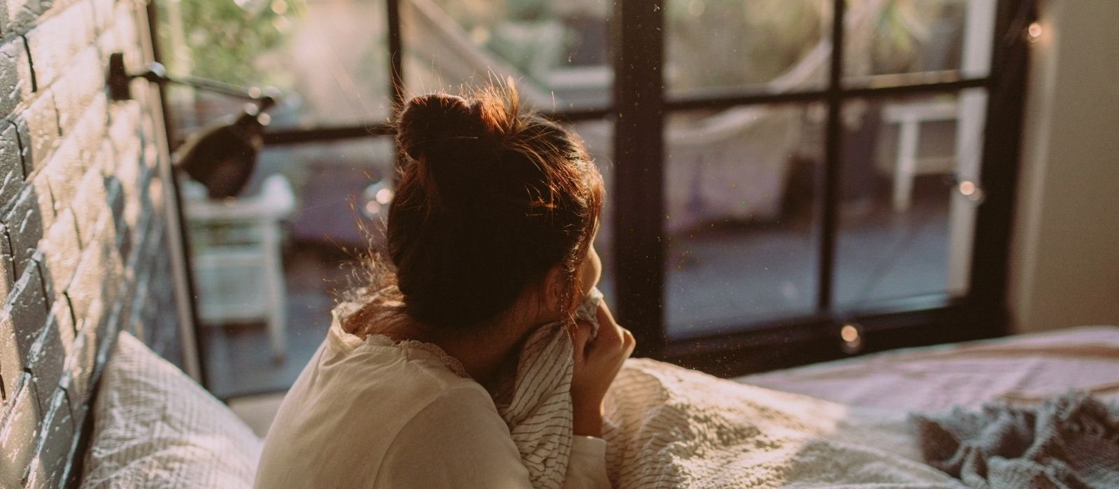 woman morning routine waking up calm sunlight