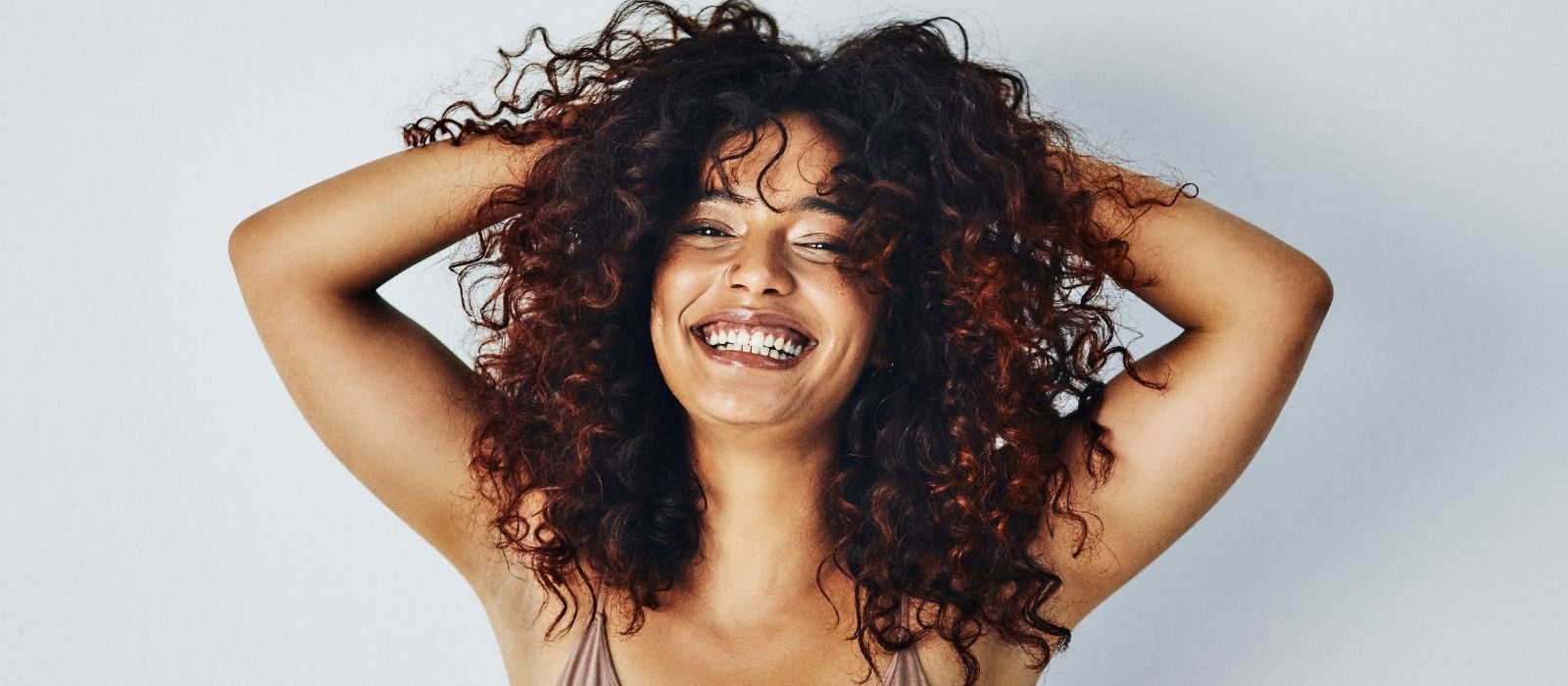 Woman with natural curly hair in warm light